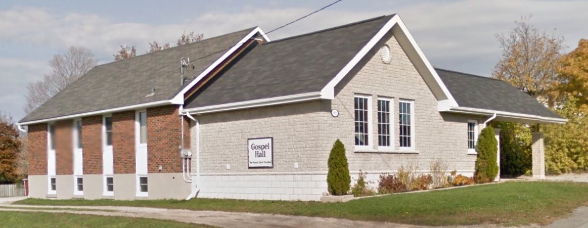 Owen Sound Gospel Hall, a low building of pale and red brick with a gabled entrance and a Gospel Hall sign on its front wall